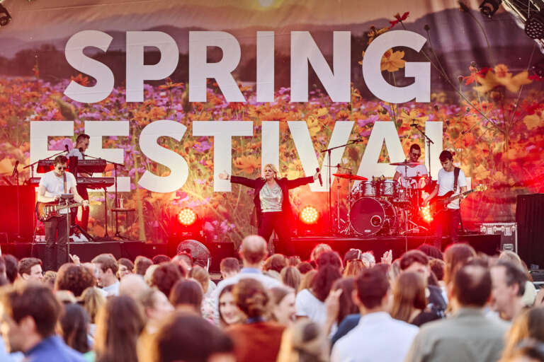 A band performs on stage in front of an excited crowd at the Spring Festival.